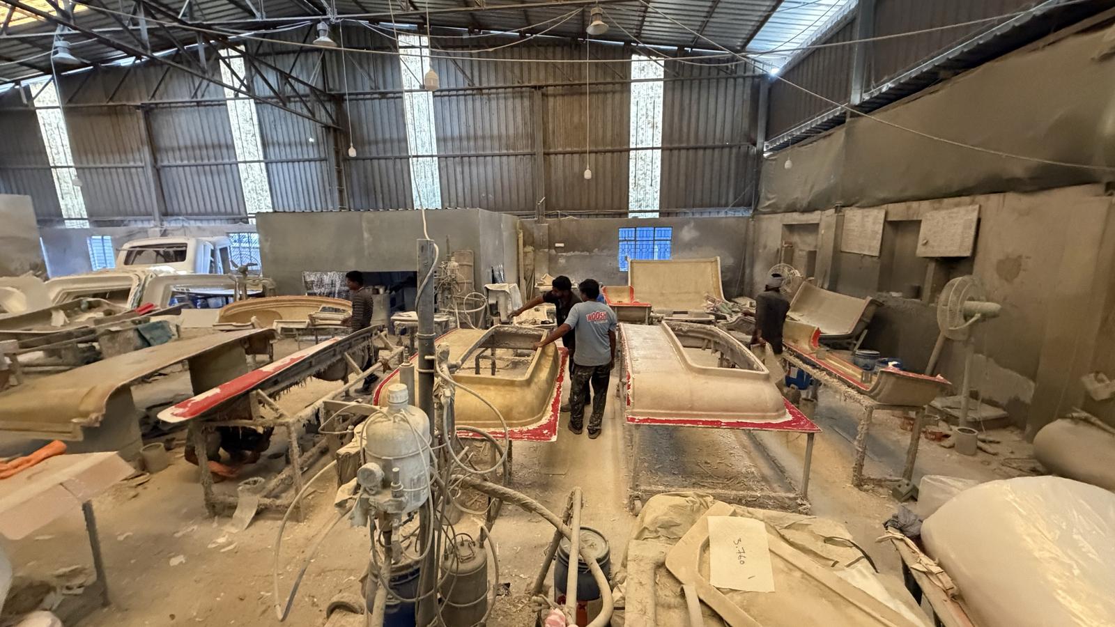 The Vikas Composites shop floor, with moulds and the gelcoat spray machine