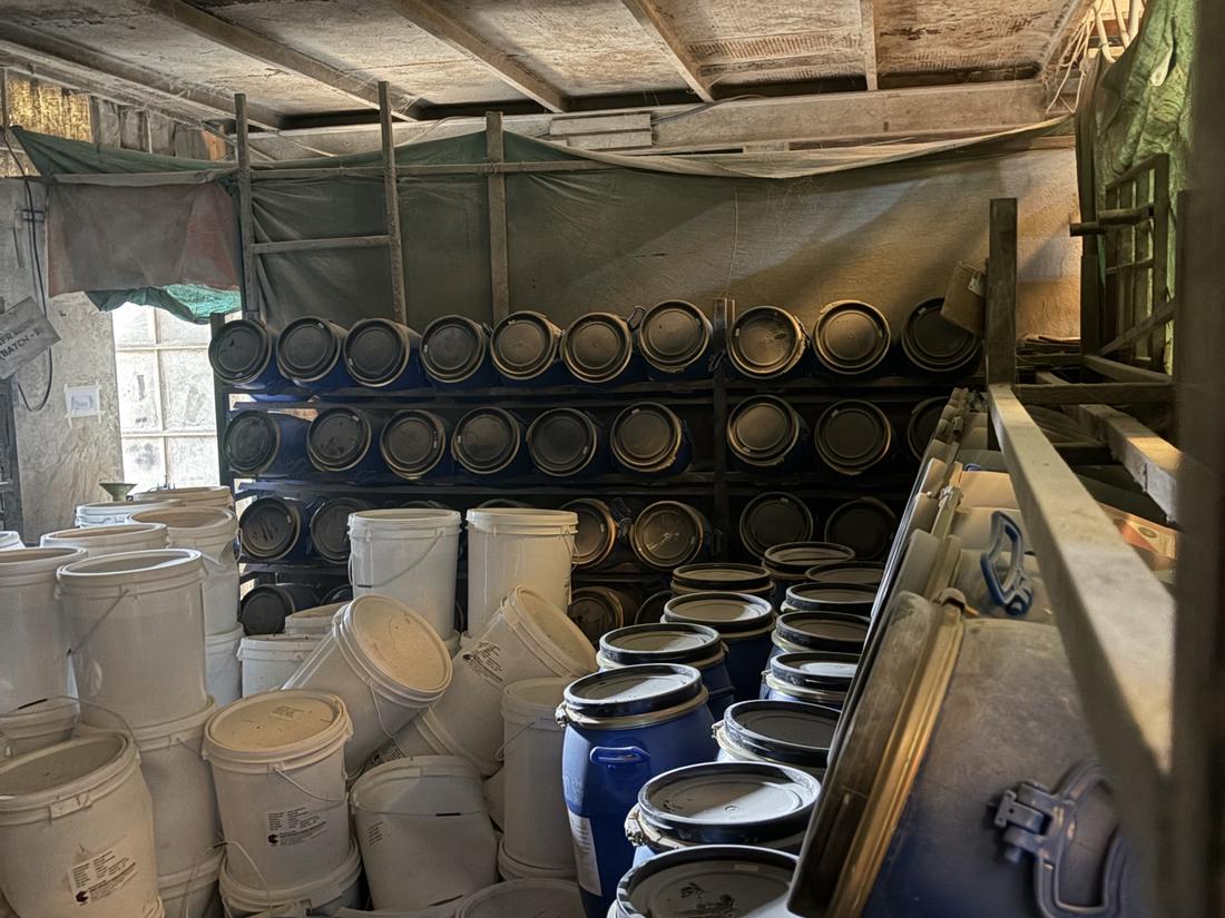 White resin pails and blue gelcoat drums in the store